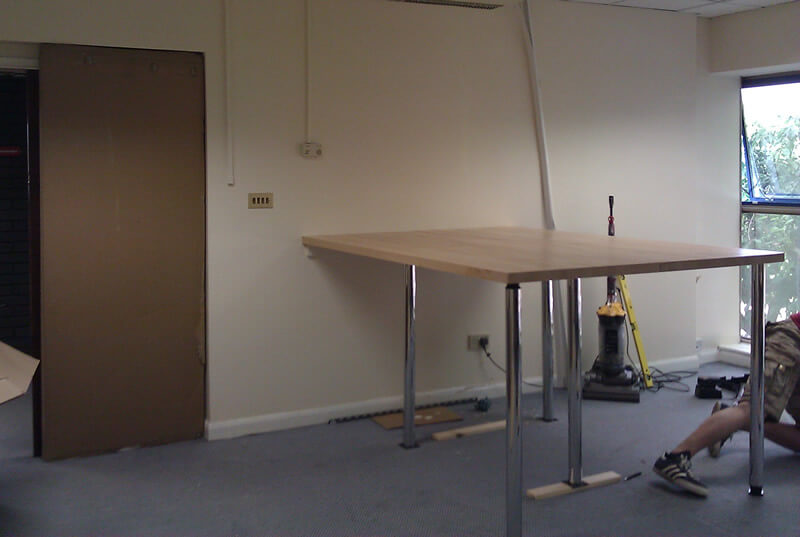 Our standing desk being built. And a pair of legs.